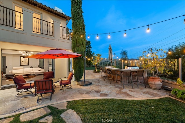 view of patio / terrace featuring outdoor dry bar, an outdoor hangout area, and a balcony