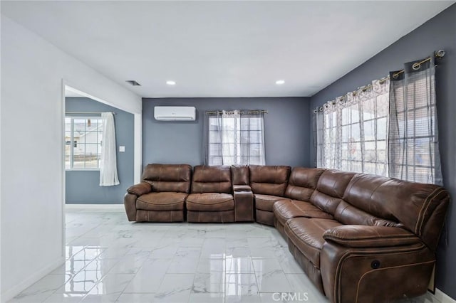 living area with a wall unit AC, marble finish floor, and plenty of natural light