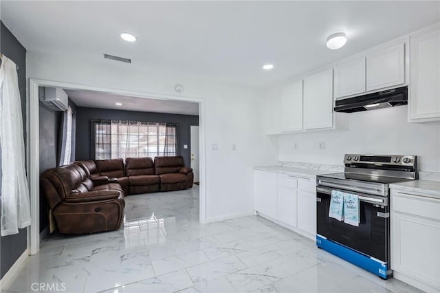 kitchen featuring under cabinet range hood, white cabinets, marble finish floor, a wall mounted AC, and stainless steel electric stove