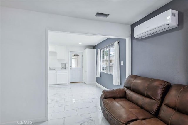 living area with marble finish floor, a wall mounted air conditioner, and baseboards