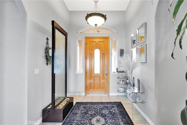 entryway featuring light tile patterned floors and baseboards