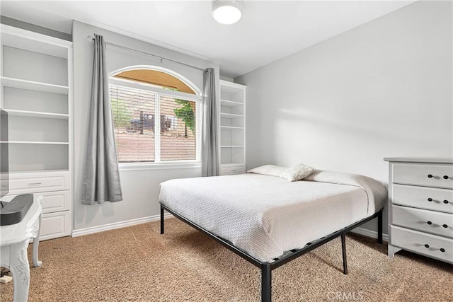 bedroom featuring carpet floors and baseboards