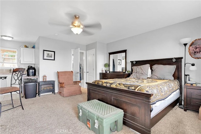 bedroom featuring ceiling fan and carpet