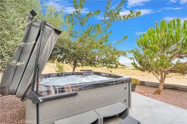 view of patio / terrace with a hot tub