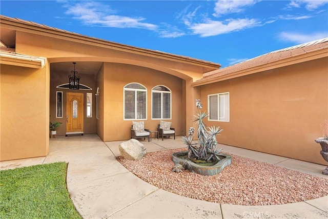 doorway to property with a patio and stucco siding