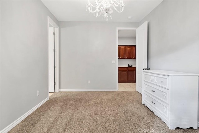 unfurnished bedroom with baseboards, a chandelier, and light colored carpet