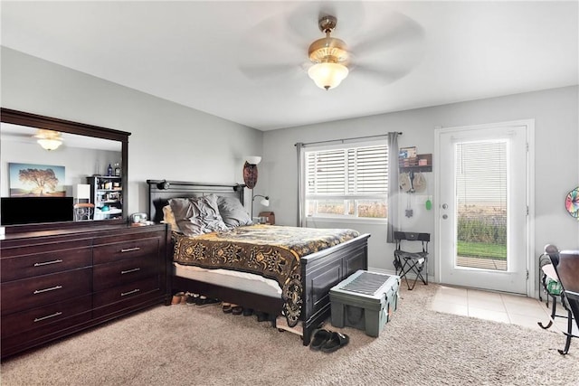 bedroom with light carpet, access to exterior, a ceiling fan, and light tile patterned flooring