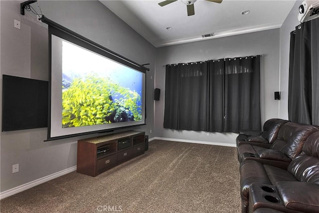 carpeted cinema room with a ceiling fan, visible vents, and baseboards