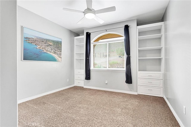 unfurnished bedroom featuring carpet floors, a ceiling fan, and baseboards