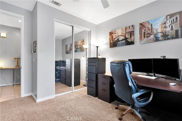 carpeted home office featuring ceiling fan, visible vents, and baseboards