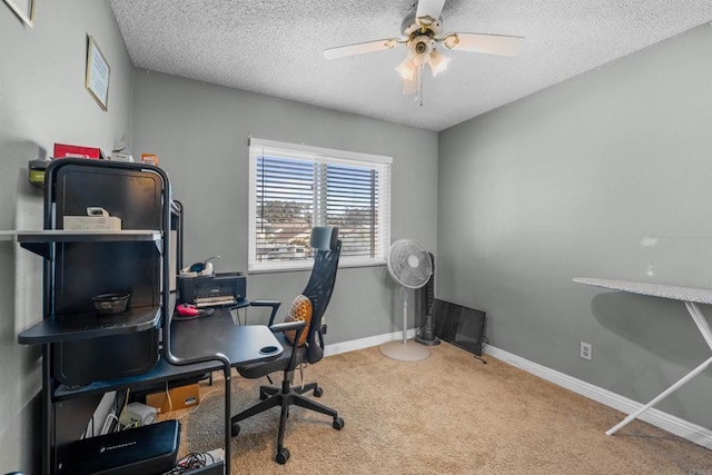 carpeted home office featuring ceiling fan, a textured ceiling, and baseboards