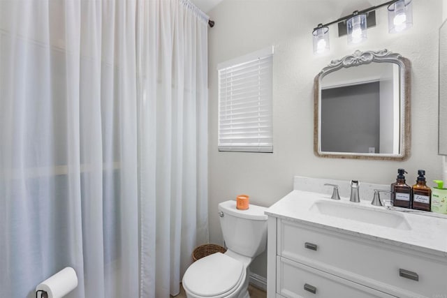 bathroom featuring vanity and toilet