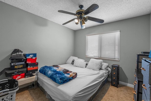 bedroom with carpet floors, ceiling fan, a textured ceiling, and baseboards