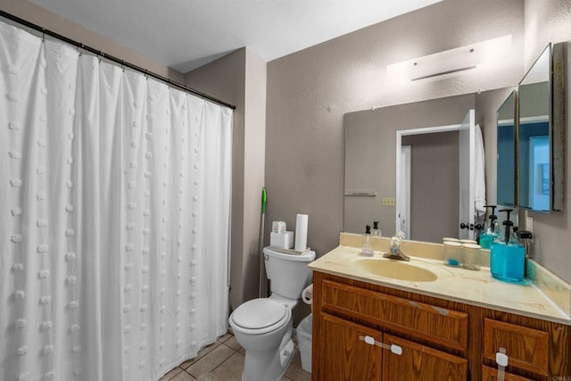 full bath with a textured wall, toilet, a shower with curtain, tile patterned flooring, and vanity