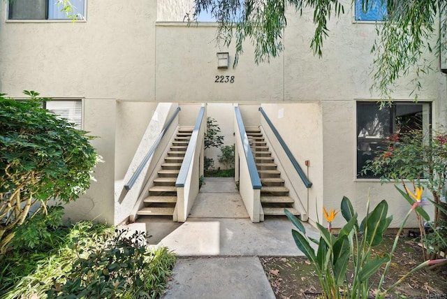 doorway to property featuring stucco siding