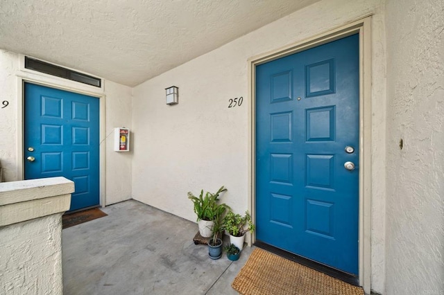 entrance to property with stucco siding