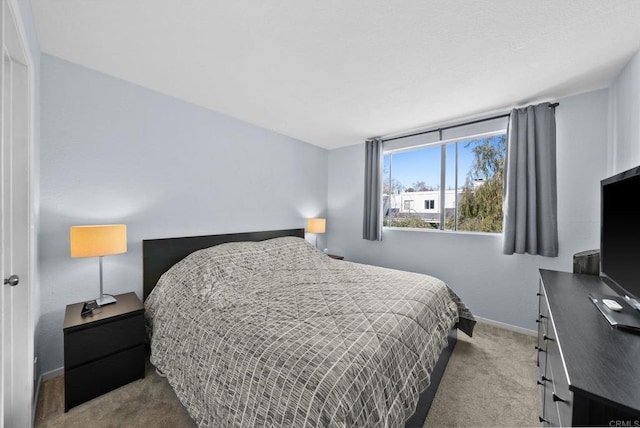 bedroom with carpet and baseboards