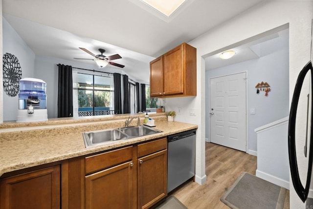 kitchen with a sink, brown cabinets, stainless steel dishwasher, and light countertops