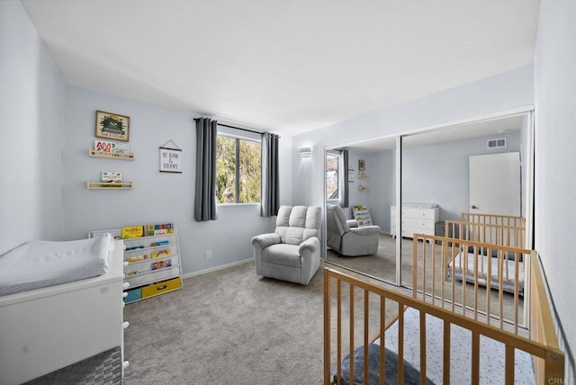 bedroom with carpet floors, baseboards, visible vents, and a closet