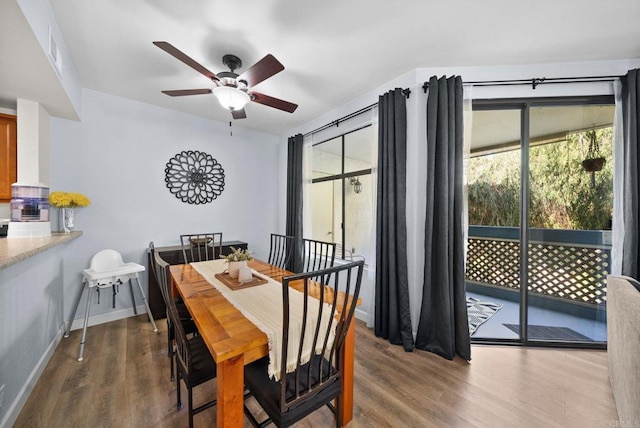 dining area featuring a ceiling fan, visible vents, baseboards, and wood finished floors