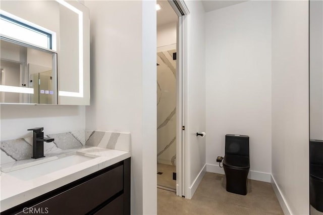 full bathroom with baseboards, toilet, a shower stall, and vanity