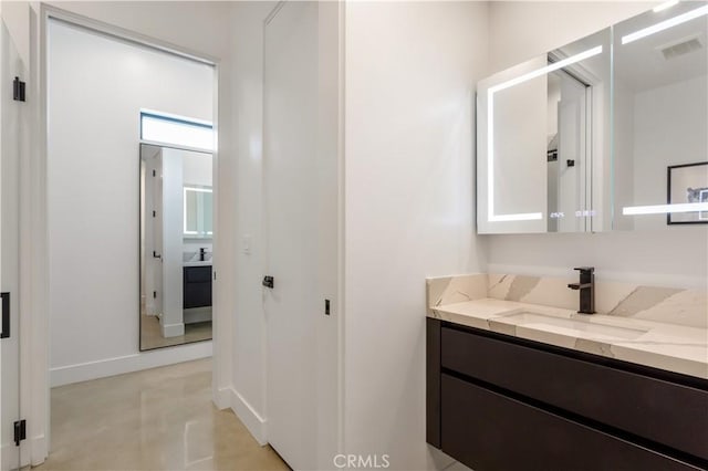 bathroom with visible vents, vanity, and baseboards