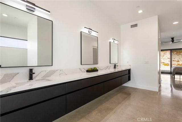 full bath featuring double vanity, ensuite bath, finished concrete floors, and a sink