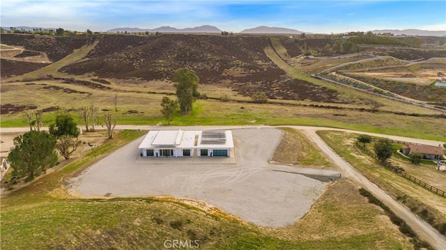 drone / aerial view featuring a rural view and a mountain view