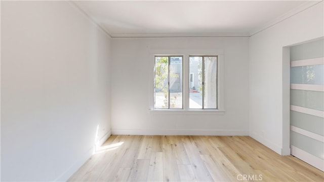 unfurnished room featuring light wood-style floors and baseboards