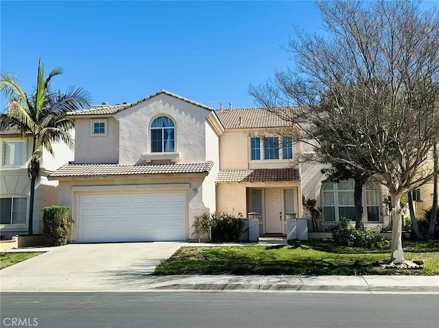 mediterranean / spanish home featuring concrete driveway, an attached garage, a tile roof, and stucco siding