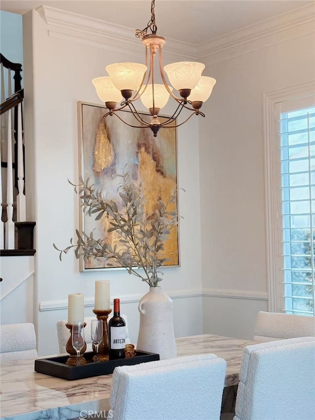 dining room with stairway, ornamental molding, and a notable chandelier