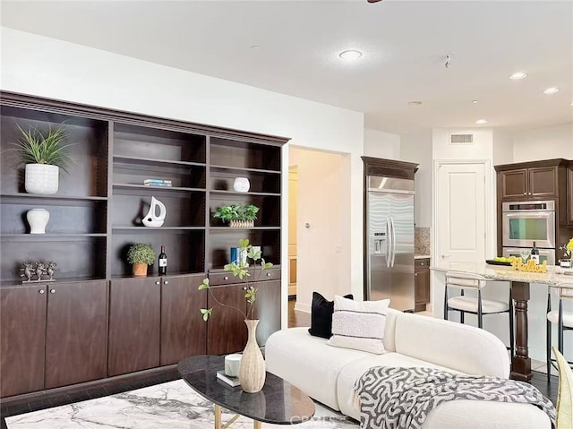 living room featuring visible vents and recessed lighting