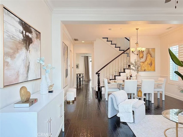 foyer featuring dark wood-style floors, a notable chandelier, stairway, ornamental molding, and baseboards