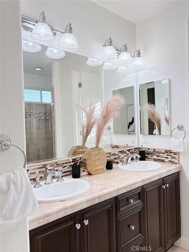 bathroom with double vanity, tasteful backsplash, and a sink