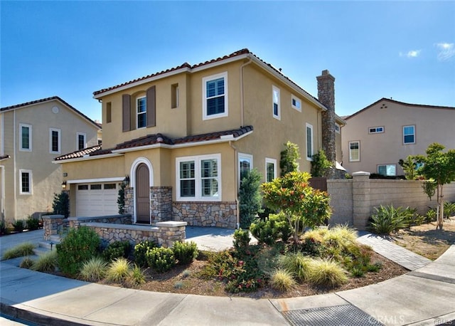 mediterranean / spanish-style house with stone siding, a tile roof, a chimney, fence, and stucco siding