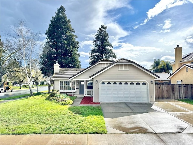 ranch-style home with a chimney, concrete driveway, an attached garage, fence, and a front lawn