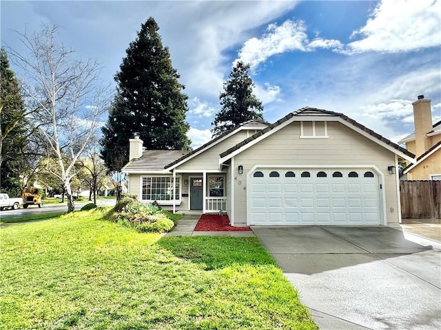 view of front of property featuring an attached garage, fence, driveway, a chimney, and a front yard