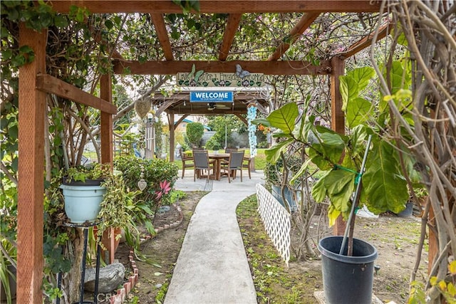 view of patio with outdoor dining area, fence, and a pergola