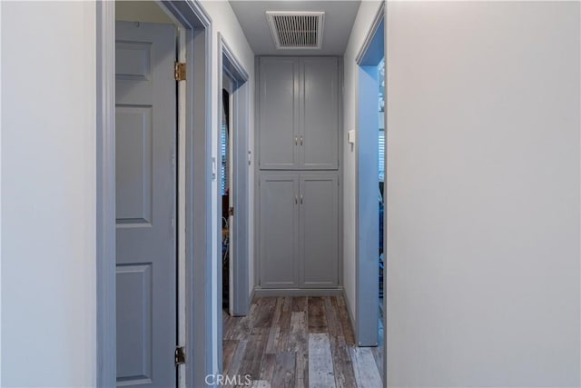 hallway featuring visible vents and light wood finished floors