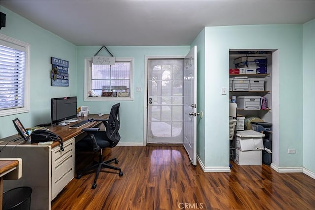 office space with dark wood finished floors and baseboards