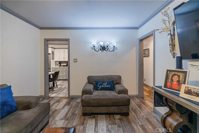 living area with baseboards, ornamental molding, and dark wood-type flooring