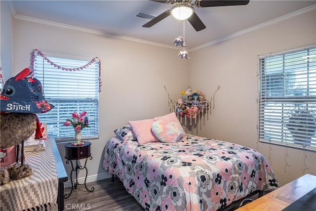 bedroom featuring multiple windows, wood finished floors, visible vents, and crown molding