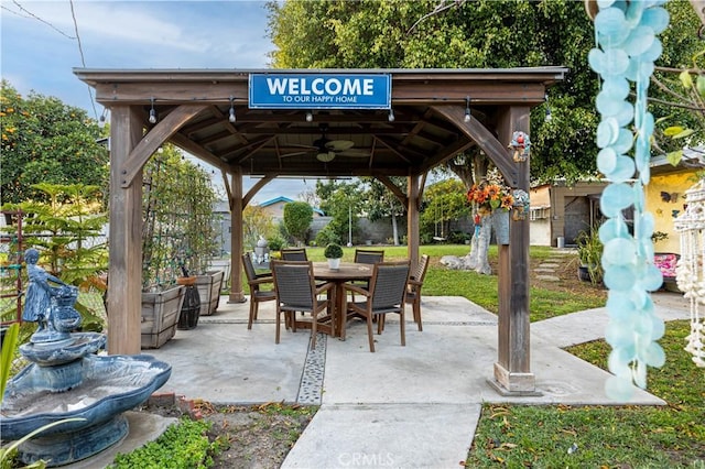 view of patio / terrace featuring a gazebo, outdoor dining area, and a ceiling fan