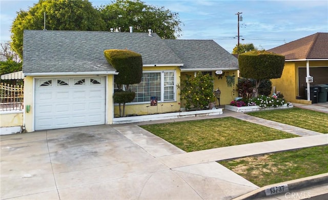 view of front of house with a garage, driveway, roof with shingles, stucco siding, and a front yard