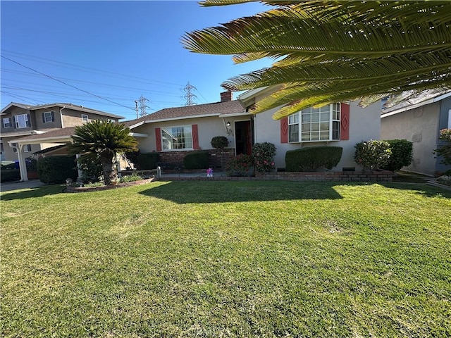 single story home featuring stucco siding, brick siding, a chimney, and a front lawn