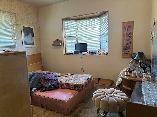 carpeted bedroom with wallpapered walls