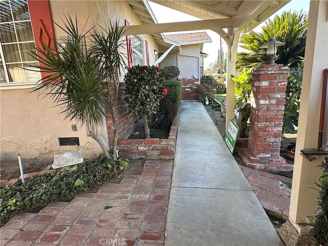 view of side of property with brick siding and stucco siding