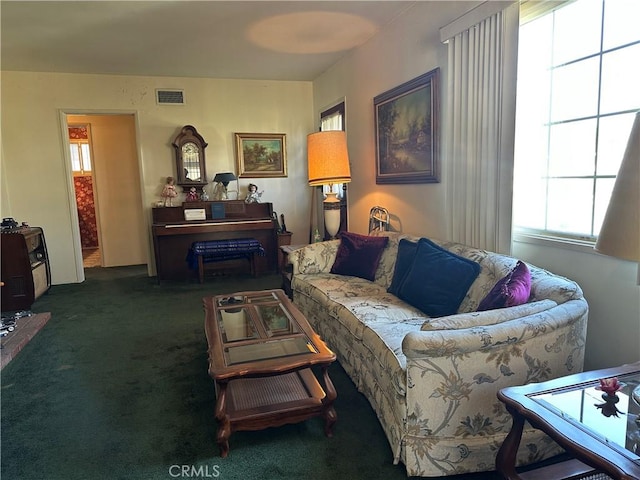 carpeted living area featuring visible vents