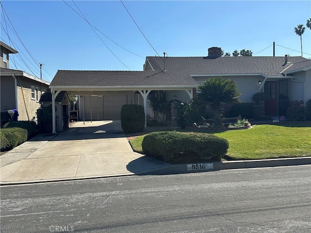 single story home with a chimney, concrete driveway, and a front lawn