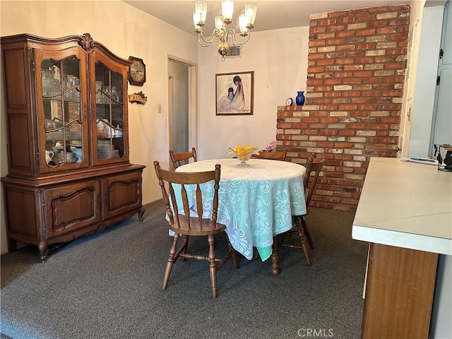 dining space featuring dark carpet and a chandelier